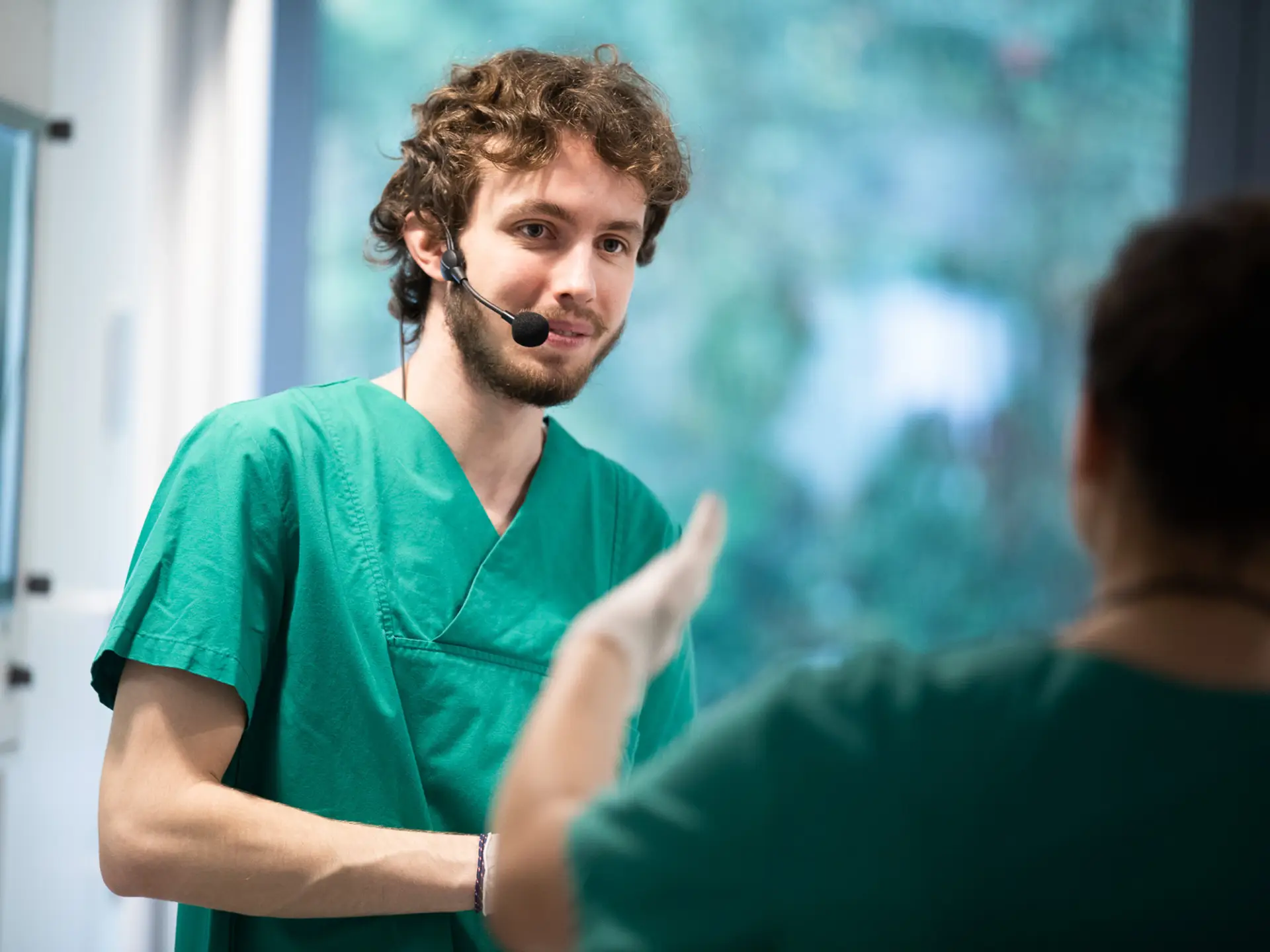 Simulation participant wearing radio microphone during a training scenario.
