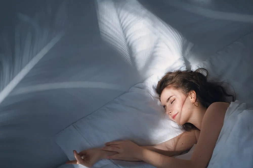 Morning of beautiful young woman in bed