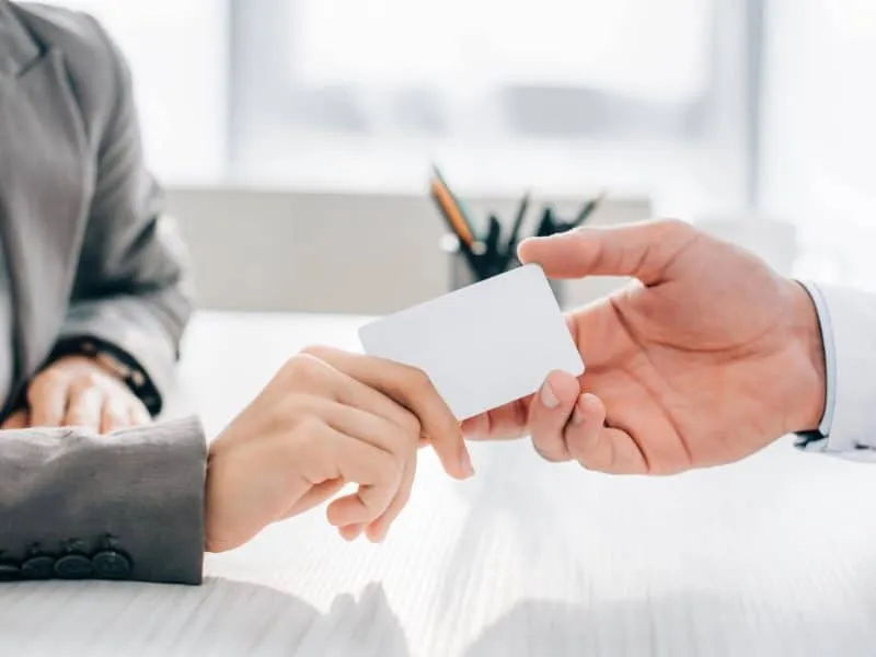 patient giving medical card to doctor