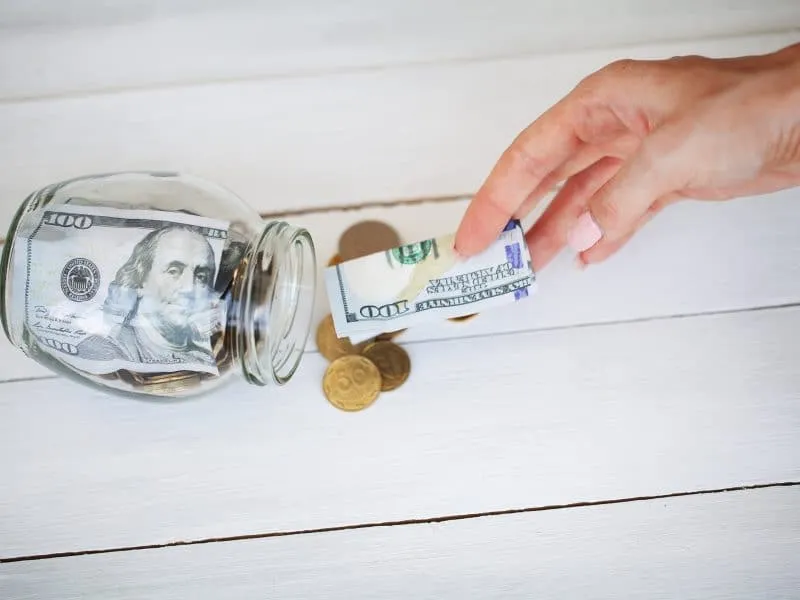 putting money in a jar