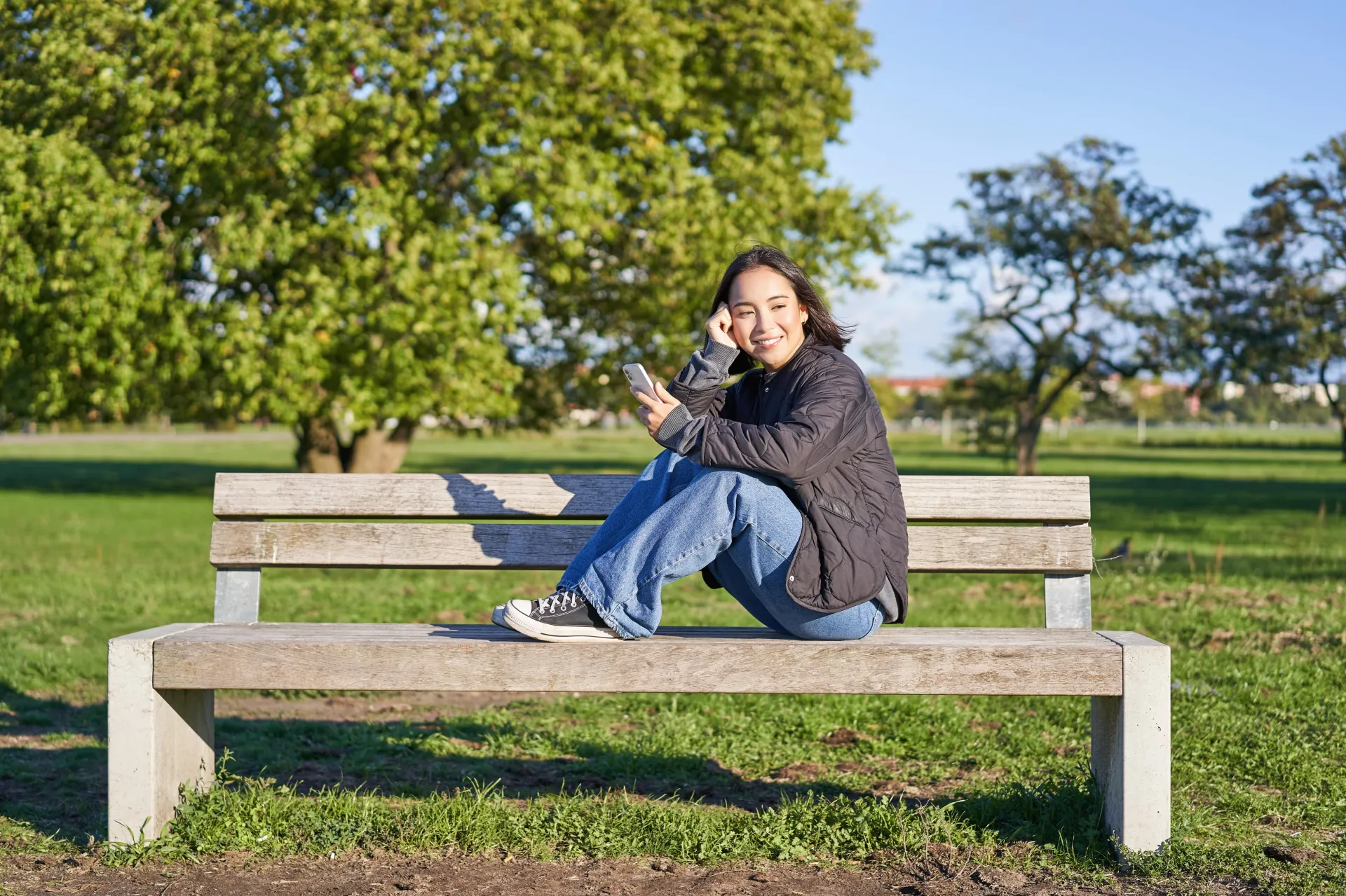 young woman sitting on bench