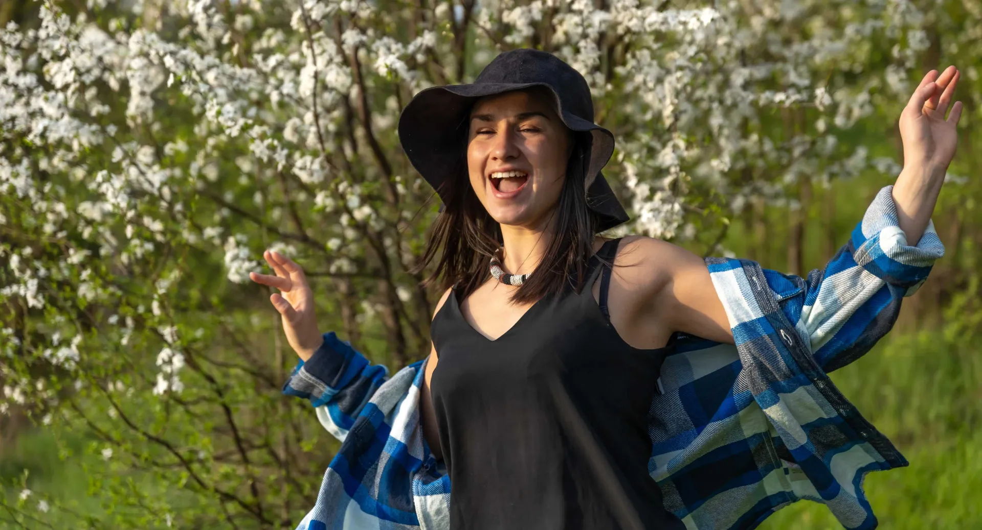 happy girl with trees behind her