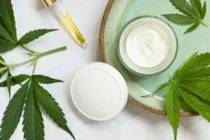 opened cream jar with cannabis