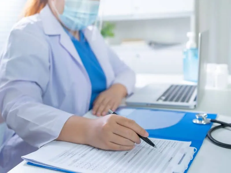 Education profession doctor in white uniform gown coat. Professional medical doctor with tablet and papers at seminar or hospital Coronavirus cancer healthcare.