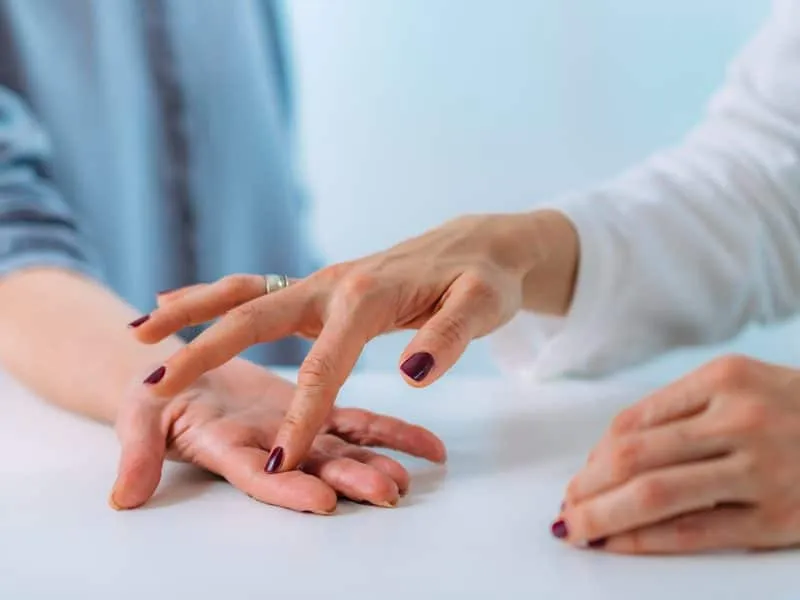 Examining the hand of a senior patient with carpal tunnel syndrome. Close-up image of senior woman’s wrist.