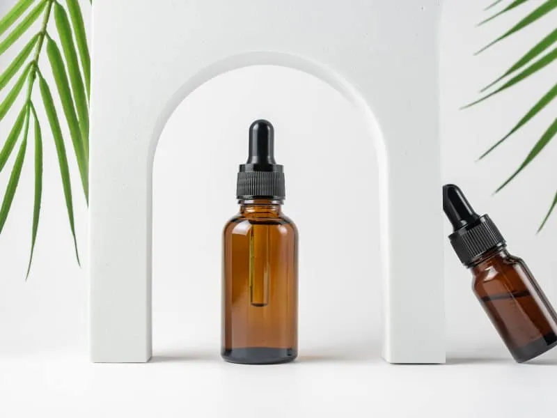 natural-skincare-product-in-glass-bottle-with-drop-2024-12-06-09-48-44-utc