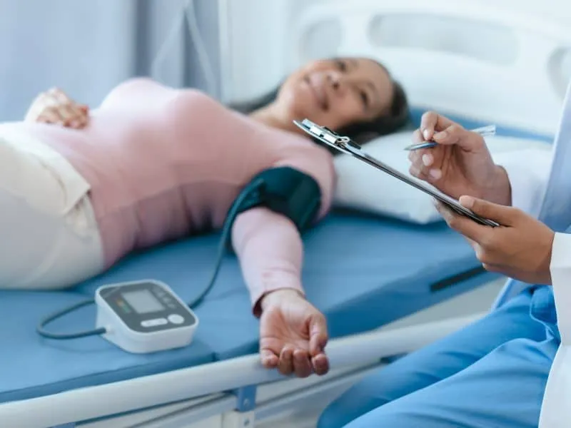 Asian Chinese female physiotherapist caregiver helping elderly woman exercise recovery