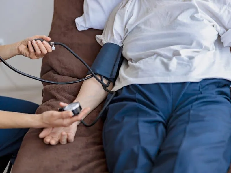 Close up of nurse checking blood pressure of woman in the ward of modern clinic. High quality photo