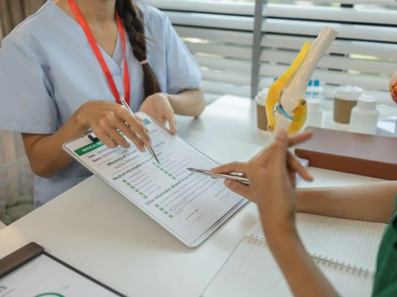 two doctors are meeting to exchange new knowledge and information they have gained form their medical seminars with each other, a senior doctor is explaining information and knowledge