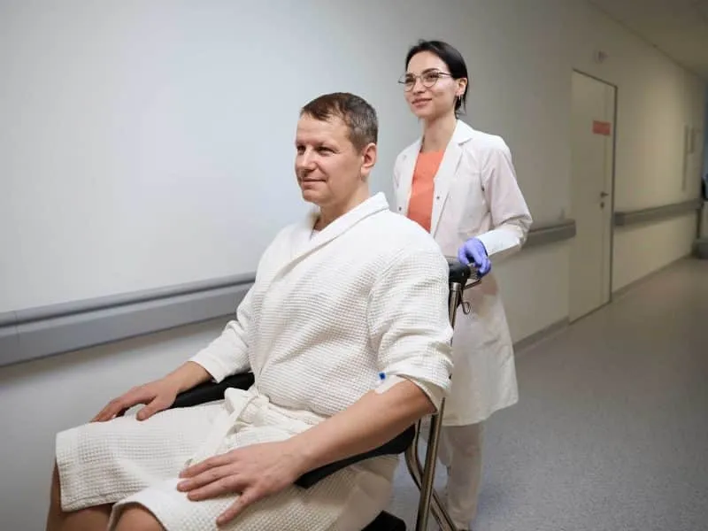 patient being carried in the wheel chair