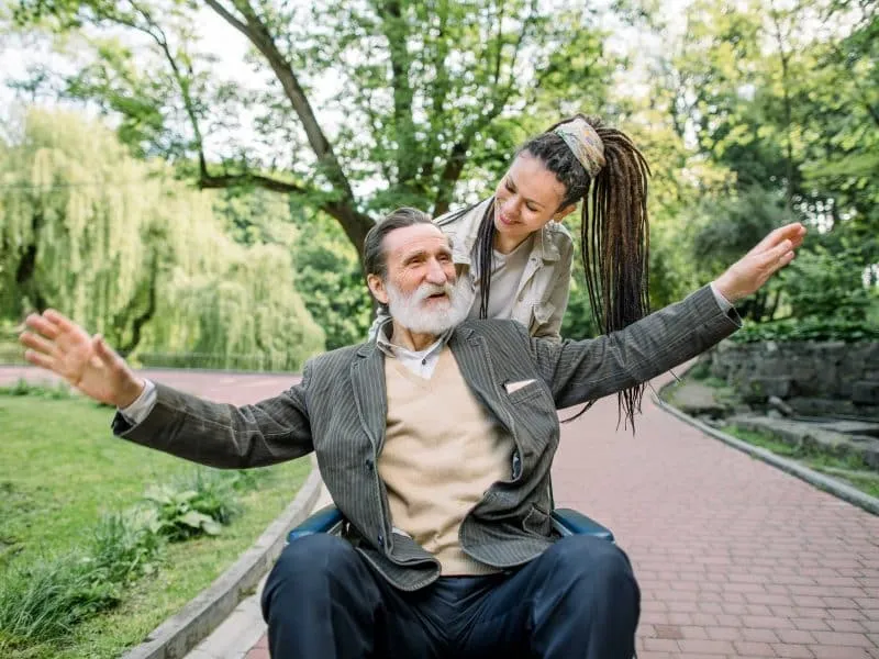 young girl assisting old man