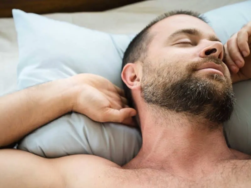 bearded man sleeping with sleep apnea