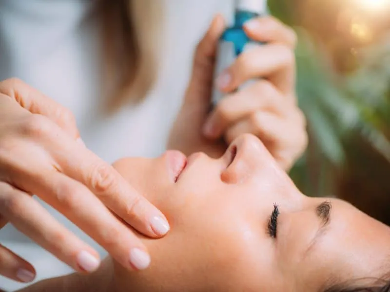 Cosmetician Applying Hyaluronic Acid Serum on Woman’s Face