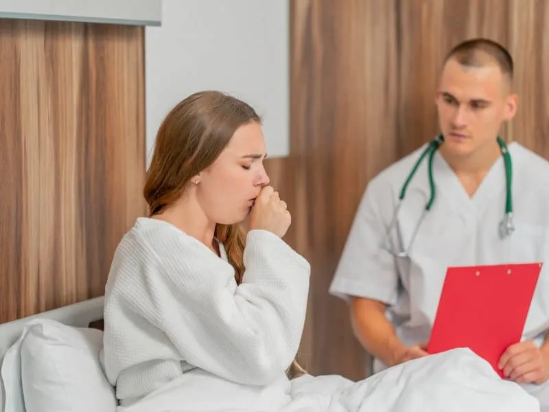 in a modern clinic in a bright VIP room, a young girl in a white coat lies on the bed, is sick, consultation with a doctor, recommendations for treatment