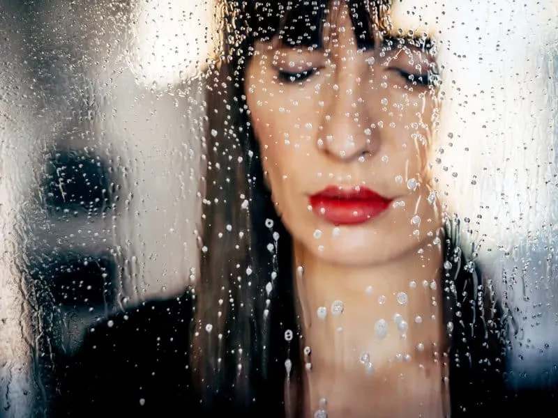 Stylish woman kissing glass