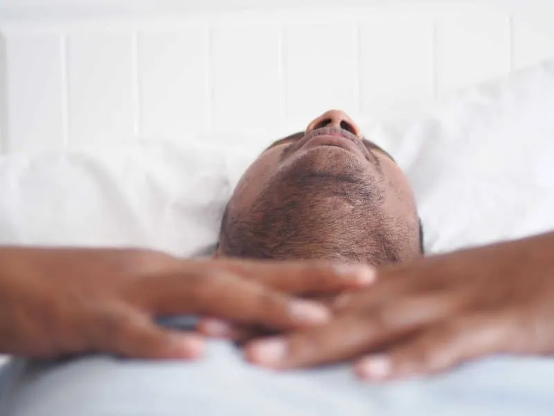 young men sleeping in bed