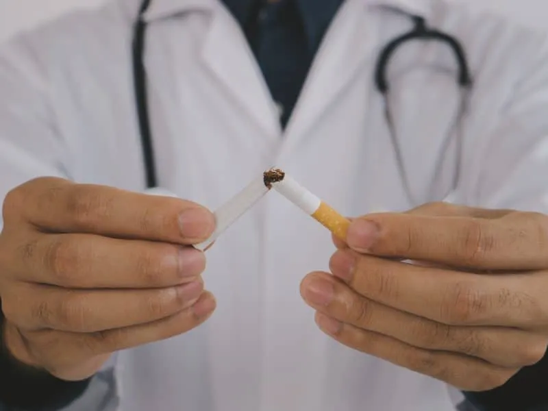 Doctor breaking a cigarette and advise patients to quit smoking. International Wold tobacco day and quit smoking cigarettes concept.