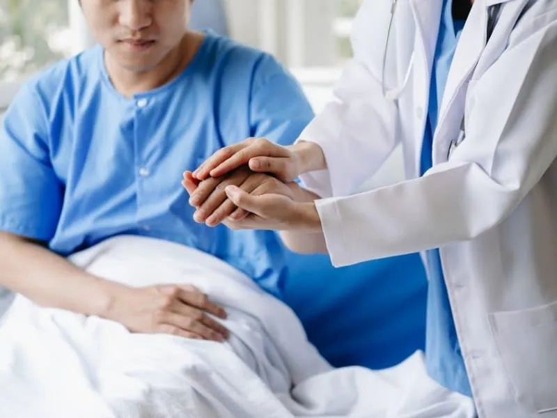 medical doctor holing patient's hands and comforting her.Kind doctor giving real support for patient.
