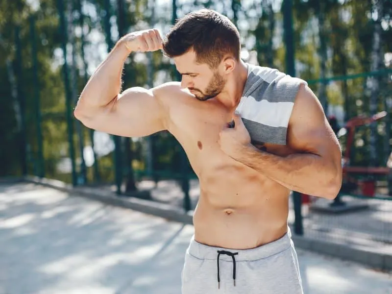 Handsome man in a park. Sportsman in a sportswear. Guy training