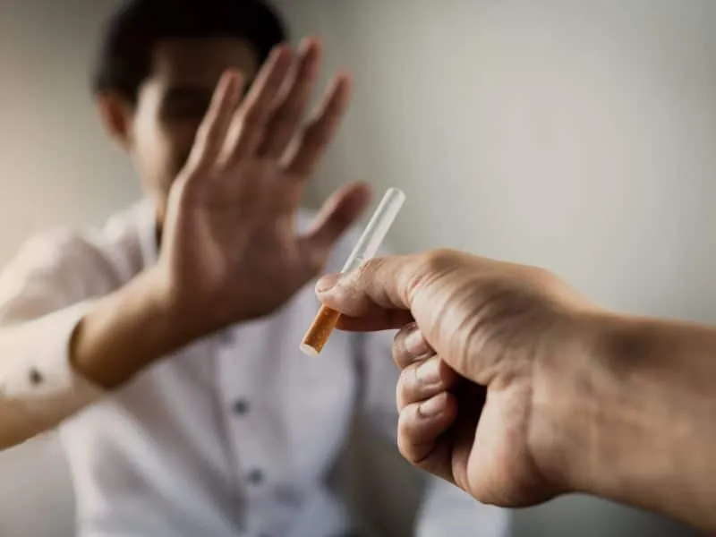 World No Tobacco Day in May, stop smoking concept, young man give cigarette but friend against and reject
