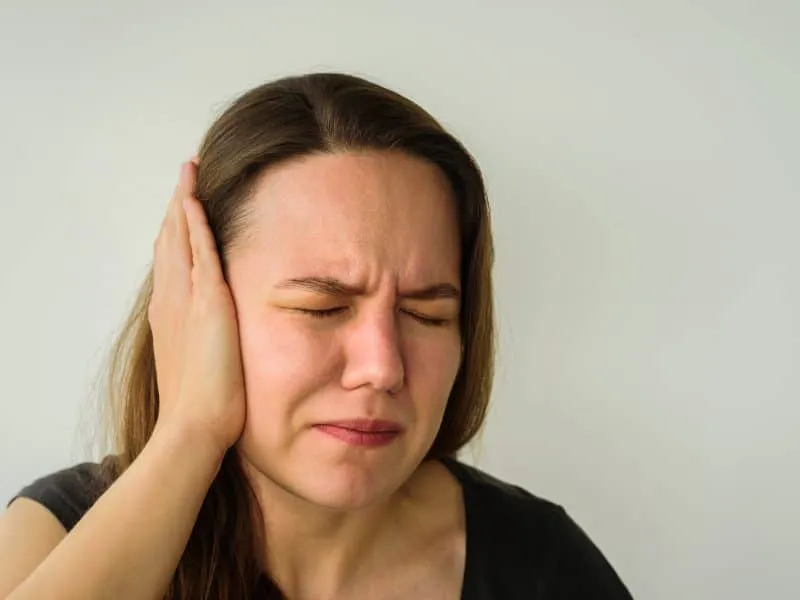 Young woman with ear pain