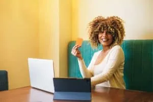 afro latin woman buying online in a cafe. High quality photo