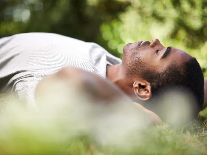 Catching a nap outdoors. Cropped shot of a handsome young man lying on the grass outdoors