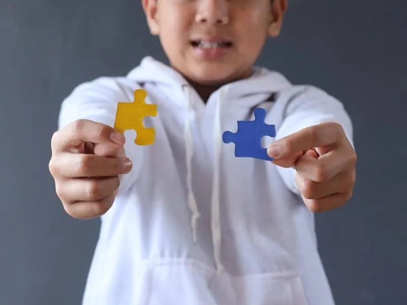 colorful-puzzle-pieces-holded-by-hands-of-young-bo-2025-03-14-23-23-16-utc