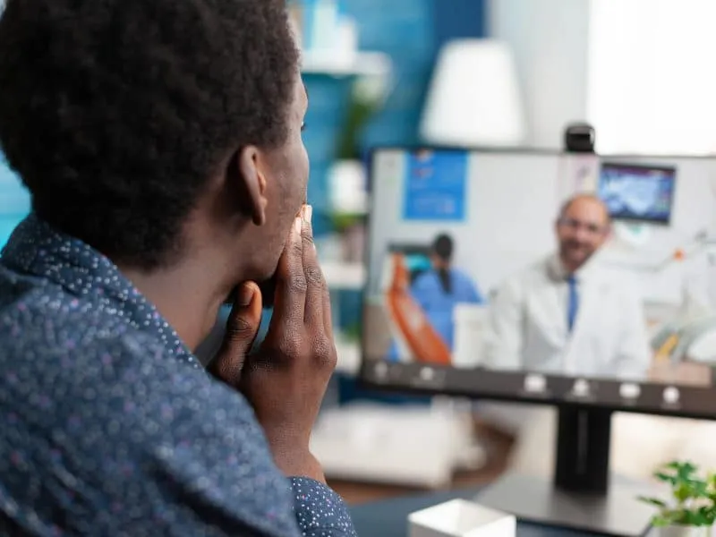 Online healthcare checkup of african american guy