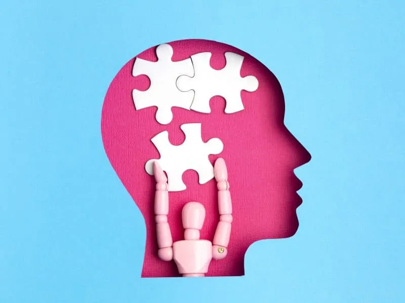 Papercut head with jigsaw puzzle pieces inside. Mental health problems, psychology, memory, logic, thinking process, solution, mental illness
