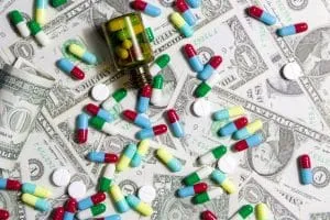 Pharmaceutical and health concept, Variety of antibiotic capsules and pills on dollar background.