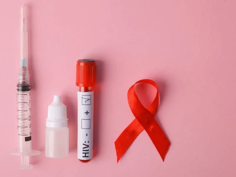 Rapid Test Kit For HIV With Injection And Red Ribbon On Pink Background. World Cancer Day.