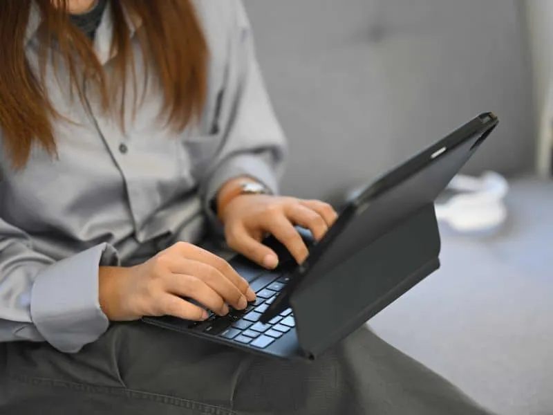 woman using her tablet to type