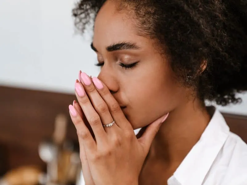Young black woman being upset and thinking about abortion at home