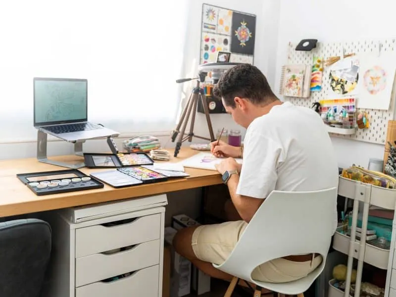man doing his work on his table
