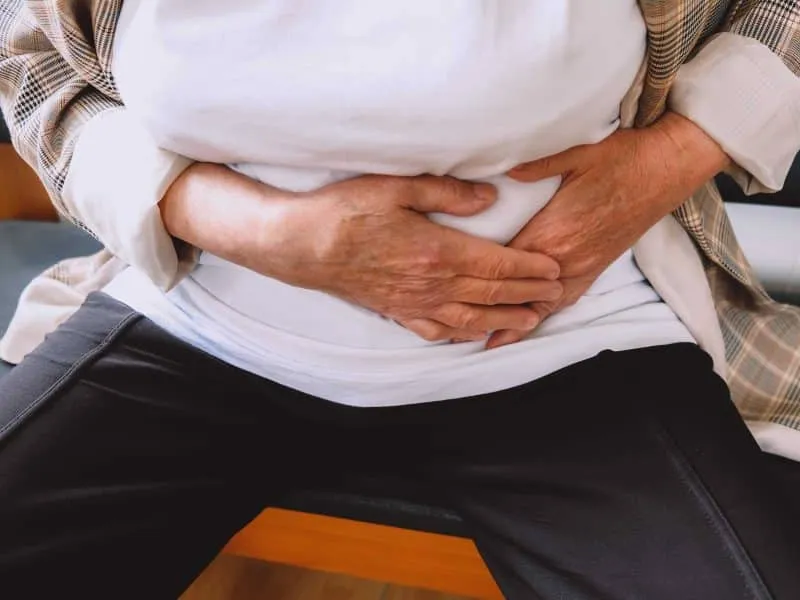 old woman holding her stomach