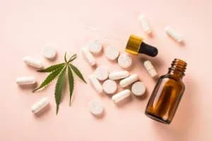 CBD pills and CBD oil in glass bottle. Herbal medicine. Sedative, antibiotic, antioxidant using.
