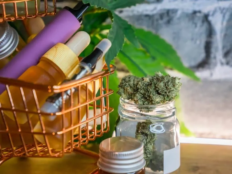 Mini shopping cart with various Medical Cannabis products on table, Shopping purchase concept of Marijuana supplements