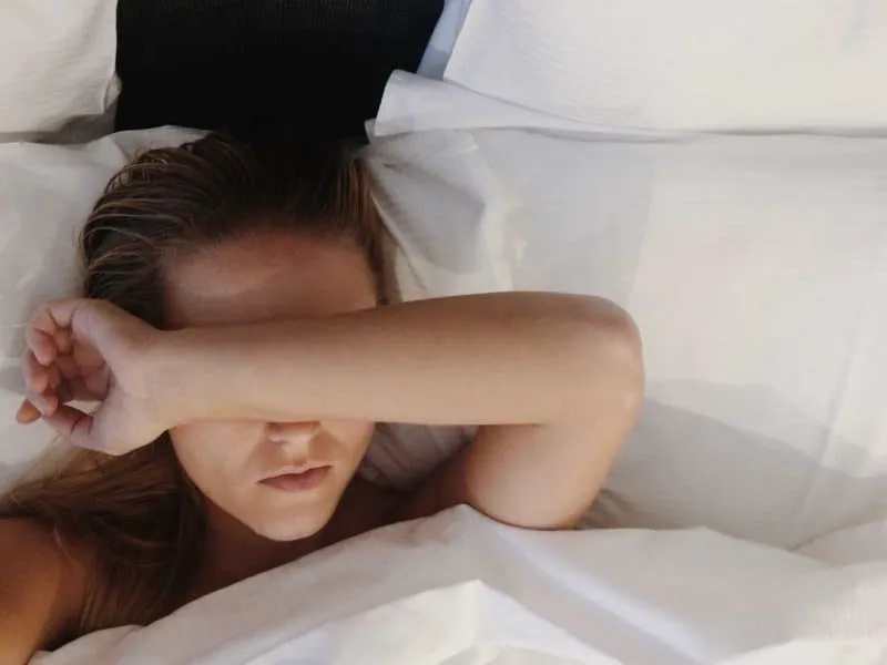 tired woman lying in bed