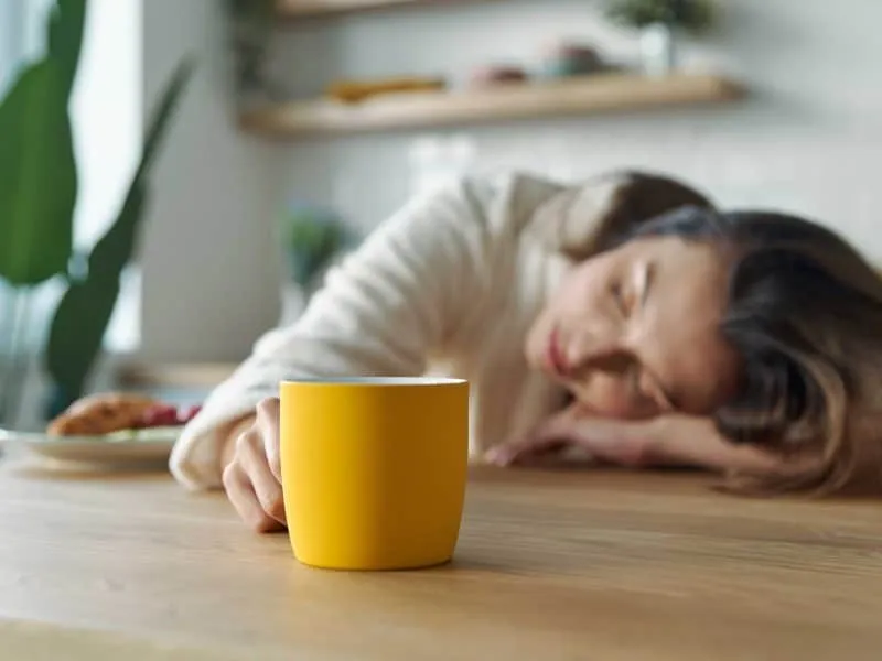 woman napping on dining table