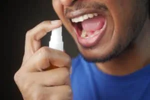 Man Applying Fresh Breath Spray