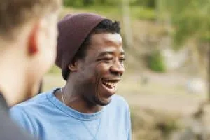 Cheerful man with friend in forest
