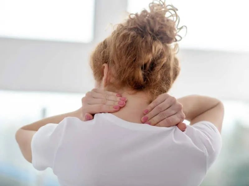 female patient massaging her painful neck