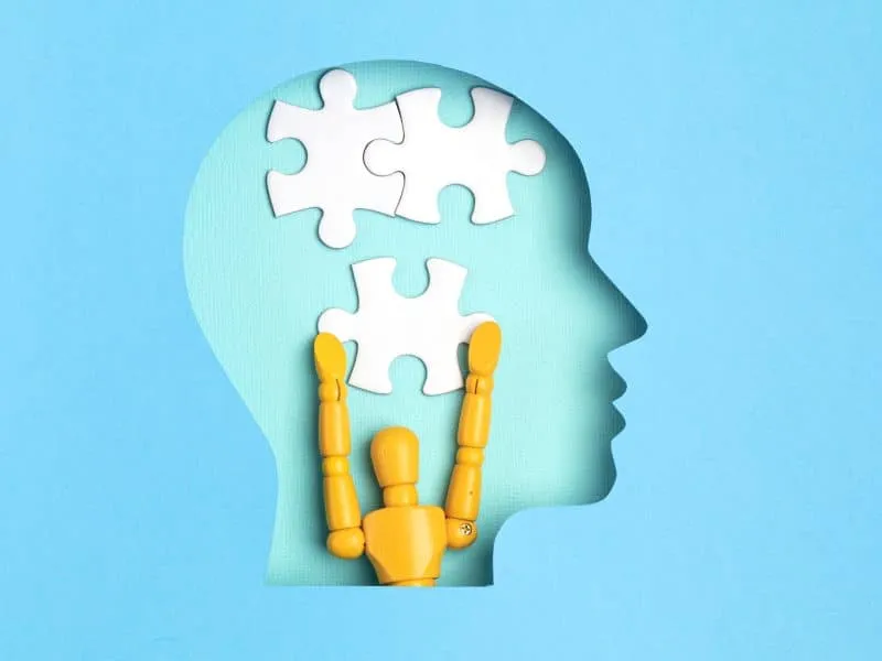 Help with mental illness concept. Papercut head with jigsaw puzzle pieces inside. Mental health problems, psychology, memory, logic, thinking process, solution search.