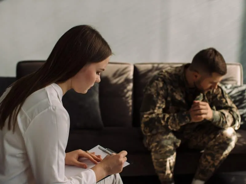 Male military officer having appointment with psychotherapist in office