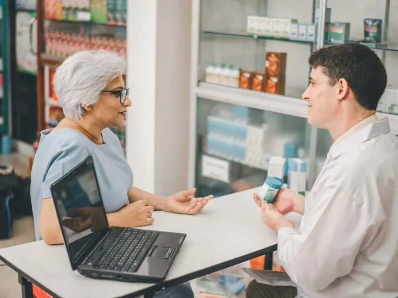 Pharmacist giving advice And advice for patients who come to buy Medicine, Drugs, Vitamins products, according to prescriptions in modern pharmacies.